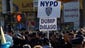 A protester holds up a sign against New York City's