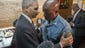 U.S. Attorney General Eric Holder talks with Capt. Ron Johnson of the Missouri State Highway Patrol at Drake's Place Restaurant in Ferguson, Mo.