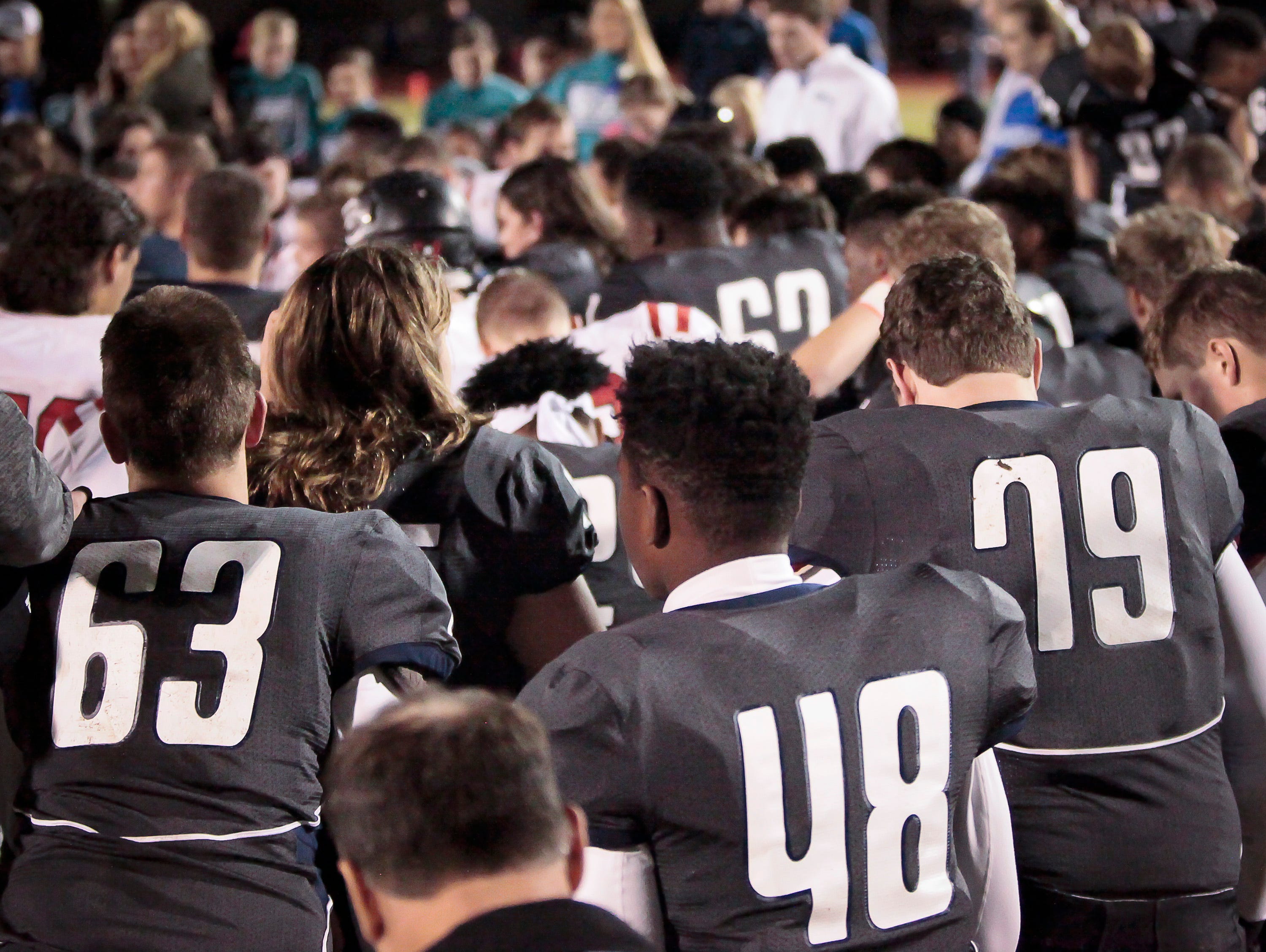 Players from both Siegel and Coffee County high schools as well as referees, cheerleaders, coaches and others gathered on the field of Friday night's game in Murfreesboro to pray for injured Siegel junior Baylor Bramble.