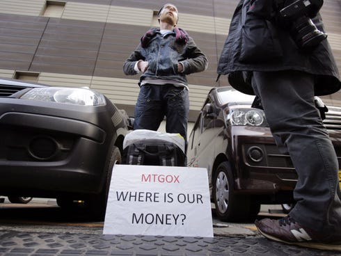 Bitcoin trader Kolin Burges stands in protest outside an office building housing Mt. Gox in Tokyo.