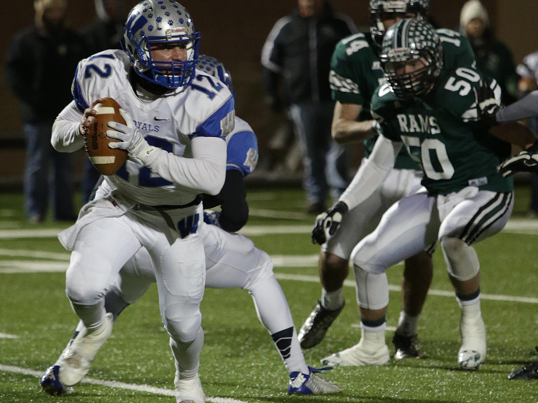 Wynford’s Keaton Teynor rolls out for a pass against Tinora in November during the Division VI regional semifinal at Dial-Roberson Stadium.