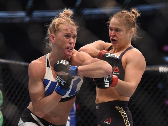 Holly Holm (left) upset Ronda Rousey with a headkick