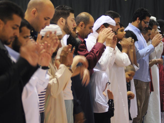 At Eid al-Adha, Muslims pray, talk clocks and politics
