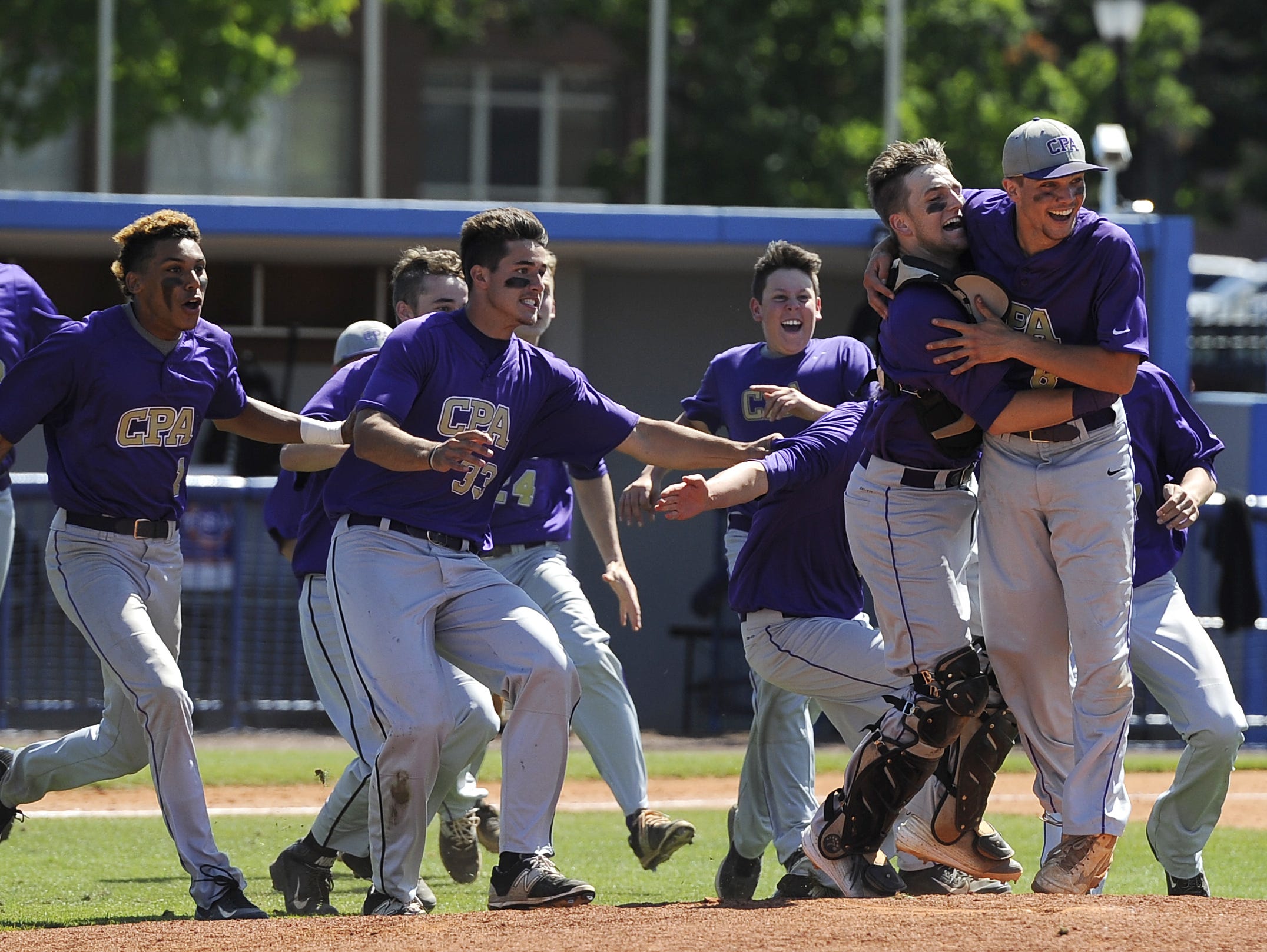 CPA catcher Philip Clarke (3), right, and pitcher Devin McKnight (8) embrace and celebrate after beating Knoxville Catholic in the 2015 TSSAA Class AA State Baseball Championship Friday.