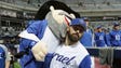 Cody Decker of Team Israel holds the team mascot, "The