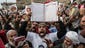 A man holds up a Quran as supporters of Egyptian President Mohammed Morsi and members of the Muslim Brotherhood chant slogans during a rally on Dec. 14, 2012, in Cairo.  Opponents and supporters of Morsi staged rallies before a referendum vote on the country's draft constitution that was rushed through parliament in an overnight session on Nov. 29.