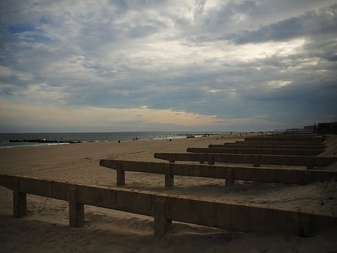 NEW YORK, NY - AUGUST 19: Remains of a section of the Rockaway boardwalk are viewed on August 19, 2013 in the Rockaways in New York City. Work continues on the Rockaway boardwalk and beach which were both heavily damaged in Hurricane Sandy. Plans for