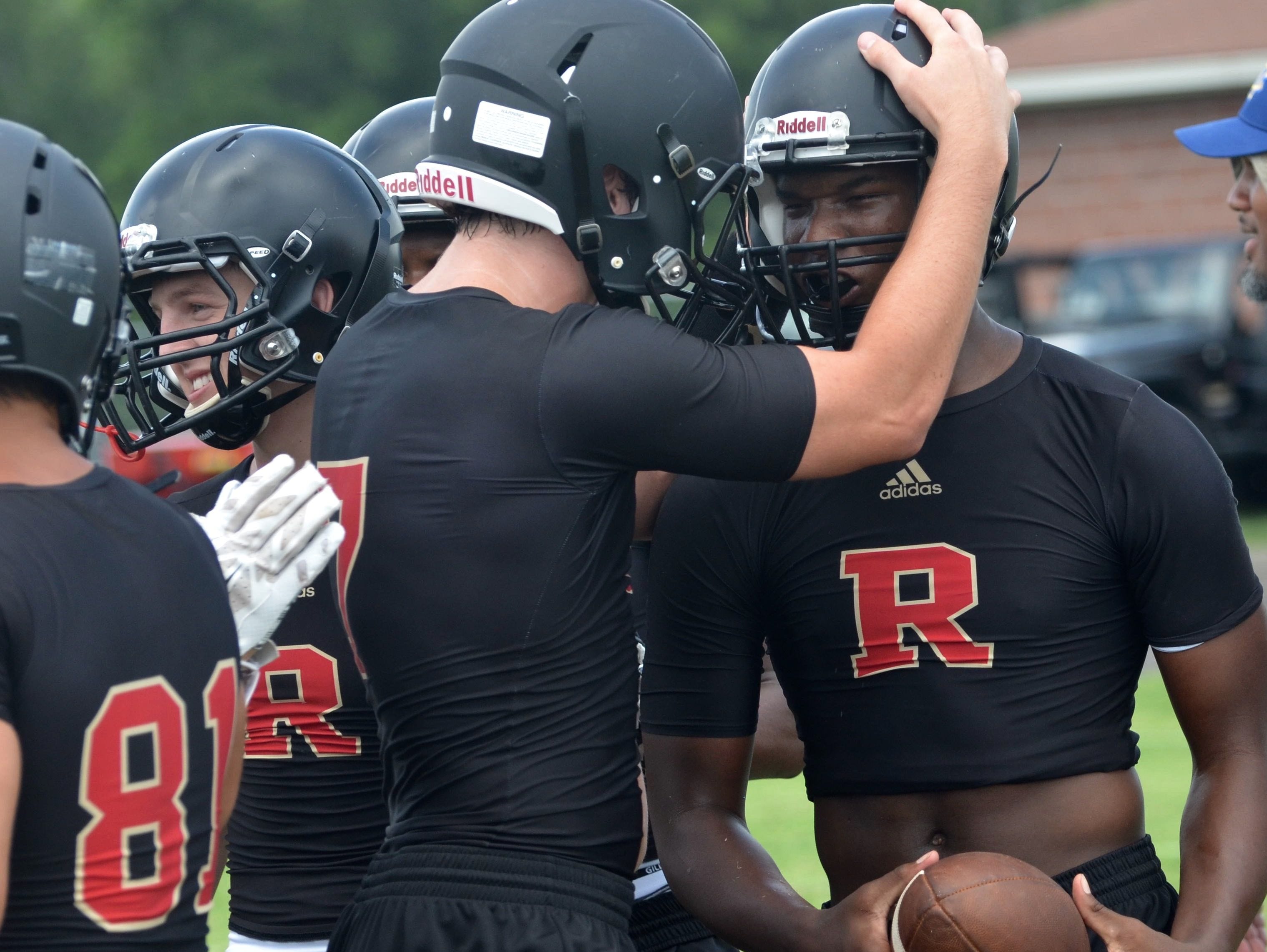 Ravenwood's Tahj Williams (right) celebrates with teammates at last year's Ravenwood 7-on-7 Invitational.
