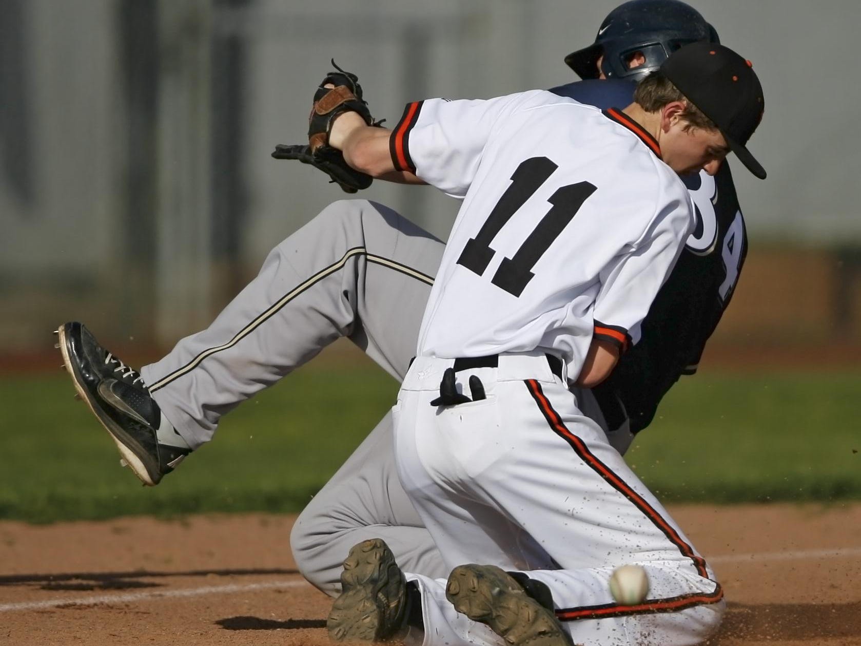 The ball gets away from Silverton third baseman Kirk Martinson as West Albany's Brett Nicholsen slides safely into third during the top of the fifth inning of Silverton's 9-2 loss in a Mid-Willamette Conference baseball game, at Silverton, on Wednesday, Apr. 30, 2914.