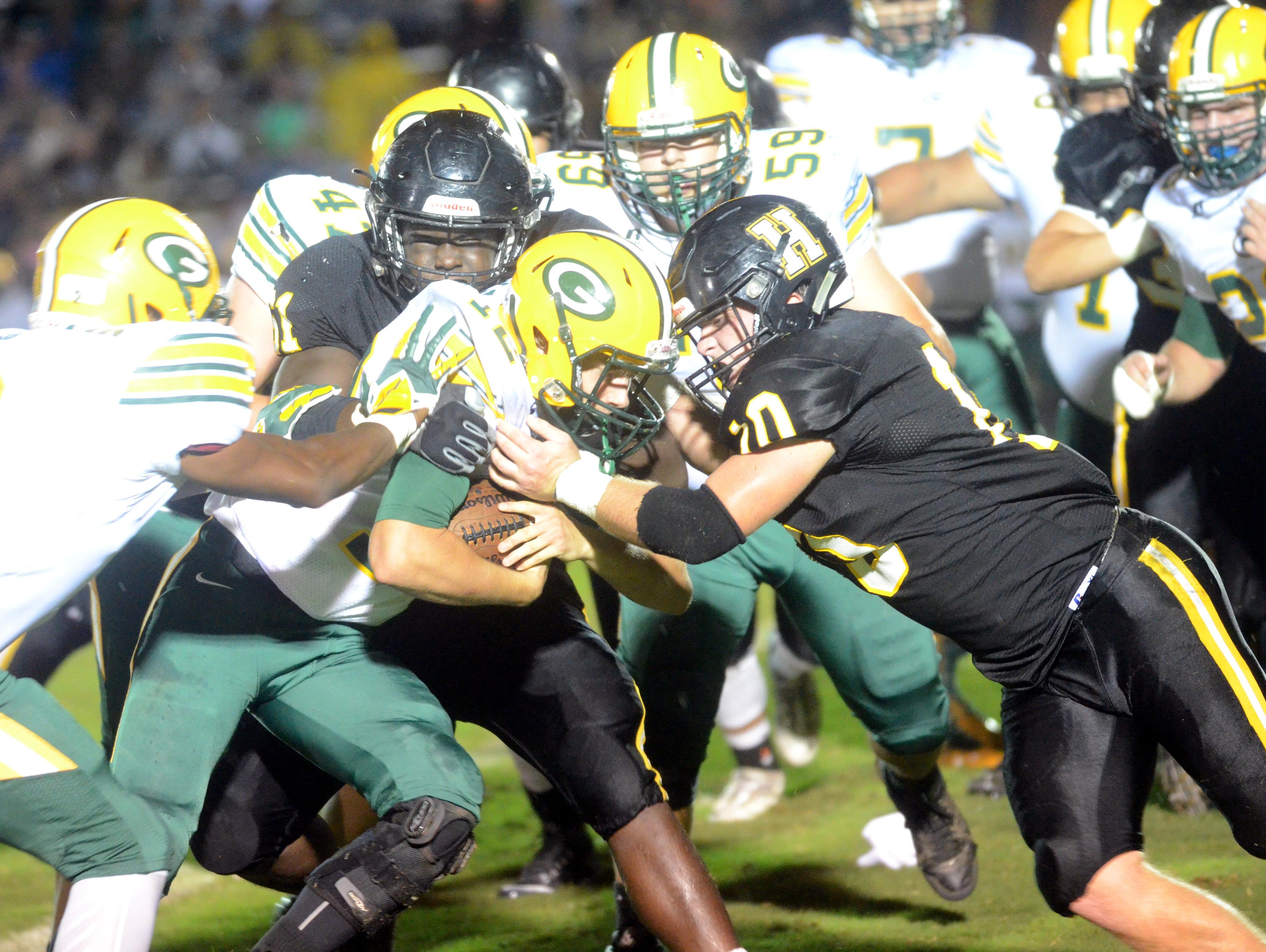 Gallatin High junior quarterback Wyatt Hayes is tackled by Hendersonville seniors Alex Tate and Jack Towe during second-quarter action.