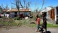 TOPSHOTS Residents walk past a house badly damaged