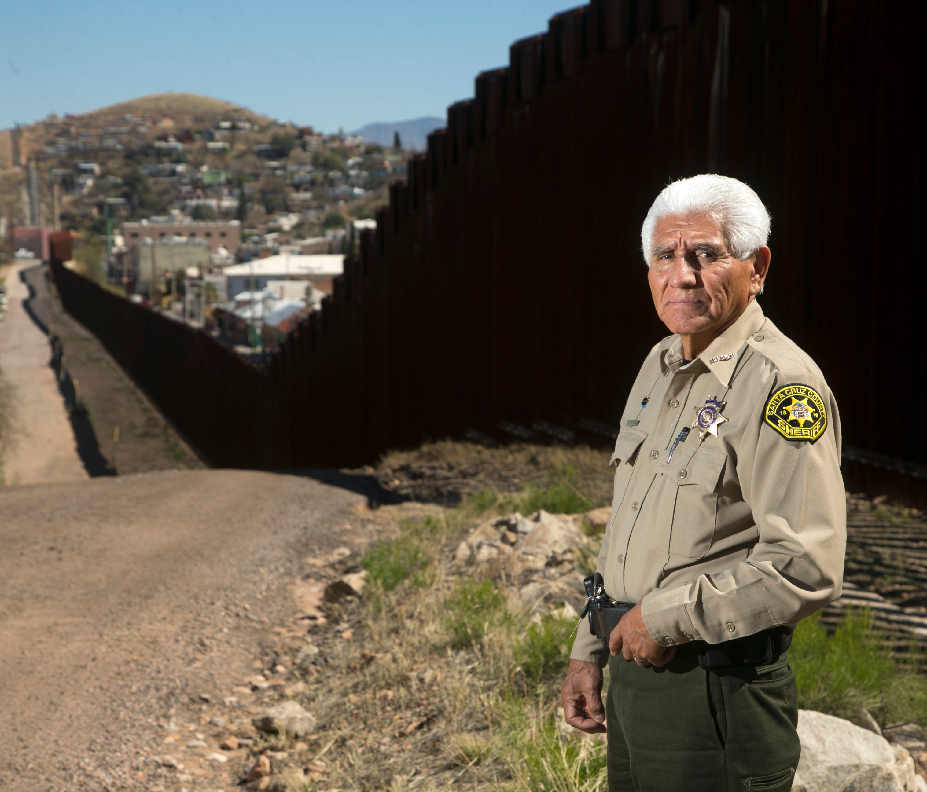 Santa Cruz County Sheriff Tony Estrada, 73, is seen along the border fence that separates the United States from Mexico in Nogales, Ariz., on Feb. 24, 2017. Estrada has been the Santa Cruz County Sheriff since 1993 and is an outspoken critic of Presi