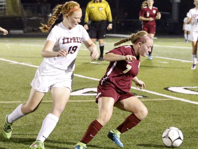 Arlington's Allie Coon controls the ball as Elmira's Caylee Boorse chases from behind Wednesday night during a Class AA girls soccer regional semifinal at Corning Memorial Stadium.