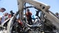 Palestinians inspect a destroyed vehicle after an airstrike in Jabalya refugee camp in the north of the Gaza Strip.