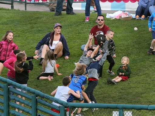 Young fans at Frontier Field chase a foul ball along
