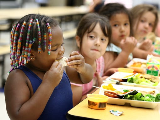 Students eat lunch at Irving Elementary School on June