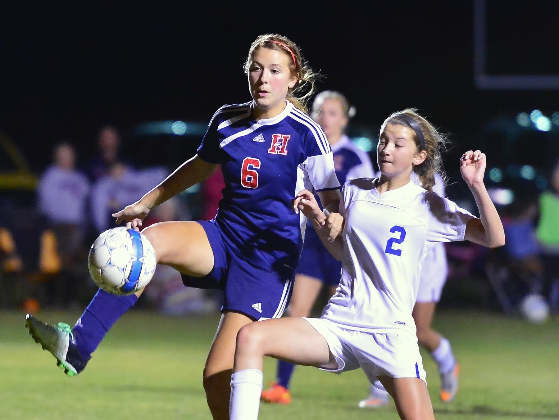 White House High freshman midfielder Shelby Deering (2) battles for possession with White House Heritage junior Sky Baker.
