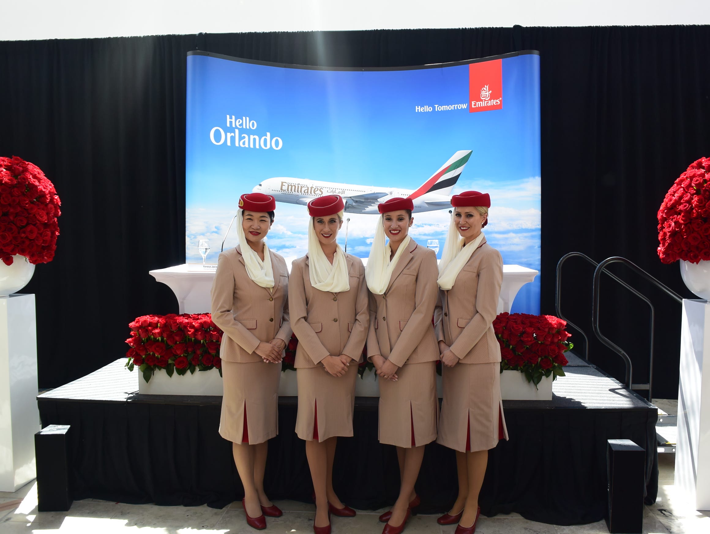 Emirates flight attendants pose for a photo ahead of a celebratory press conference for the airline's inaugural Orlando flight on Sept. 1, 2015.