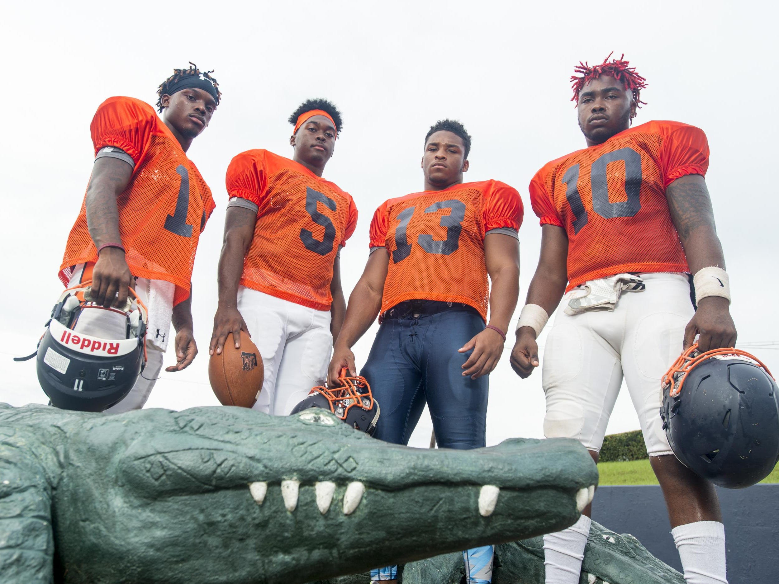 Football players (left to right) Martin McGhee (11), Z'khari Blocker (5), Shountrell Hills (13), and Amarquez Moore (10) at Escambia High School in Pensacola, FL on Monday, August 8, 2016.
