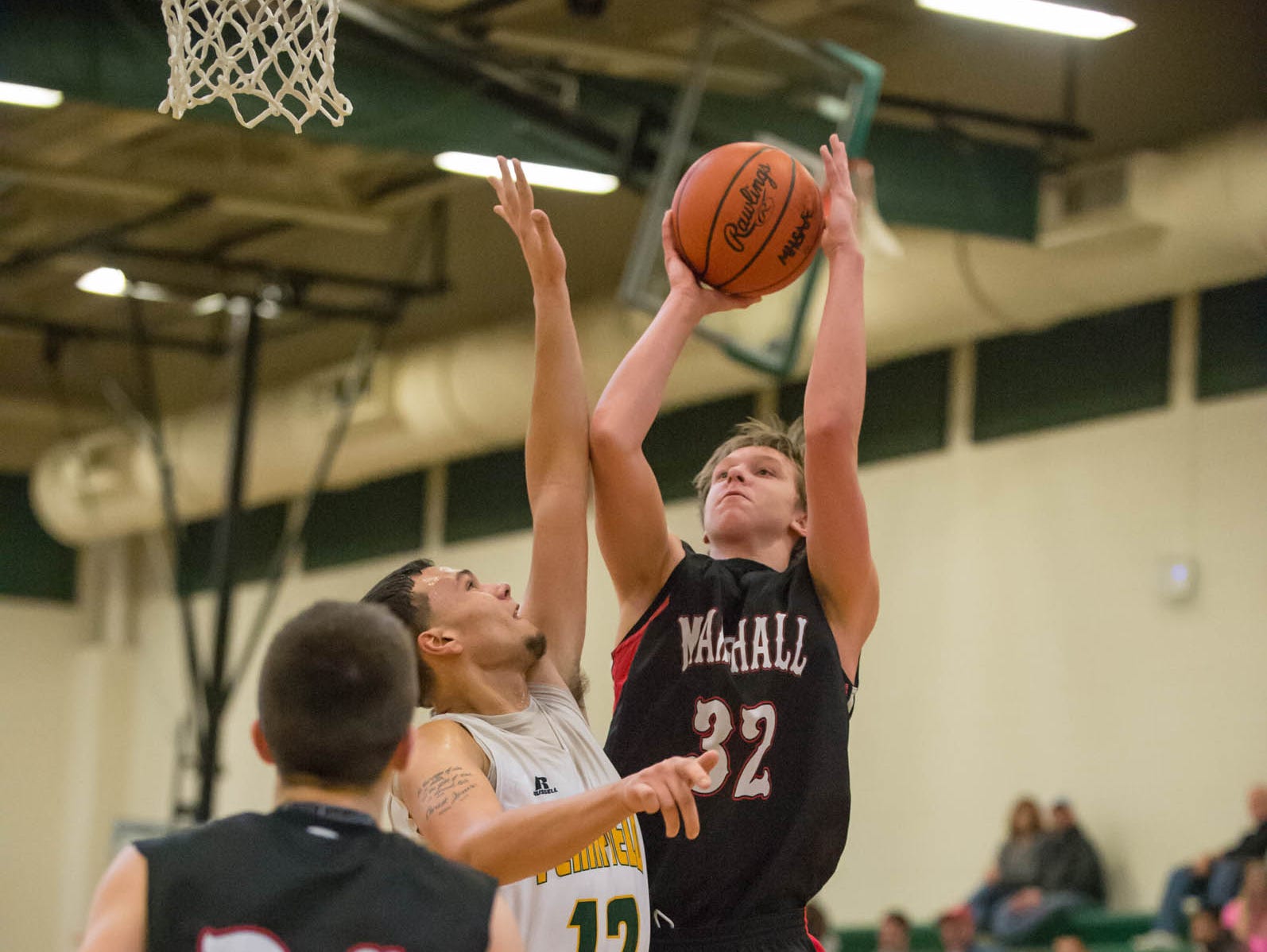 Marshall's Mitch Avery (32) takes a shot during Friday night's game.