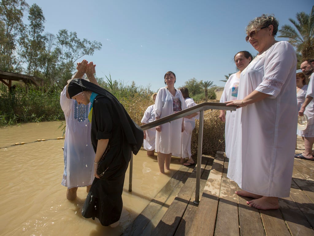 Christian pilgrims perform baptisms at the Qasr al Yahud site on the Jordan River, near the West Bank city of Jericho.The site is believed to be the place where Jesus was baptized by John the Baptist.
