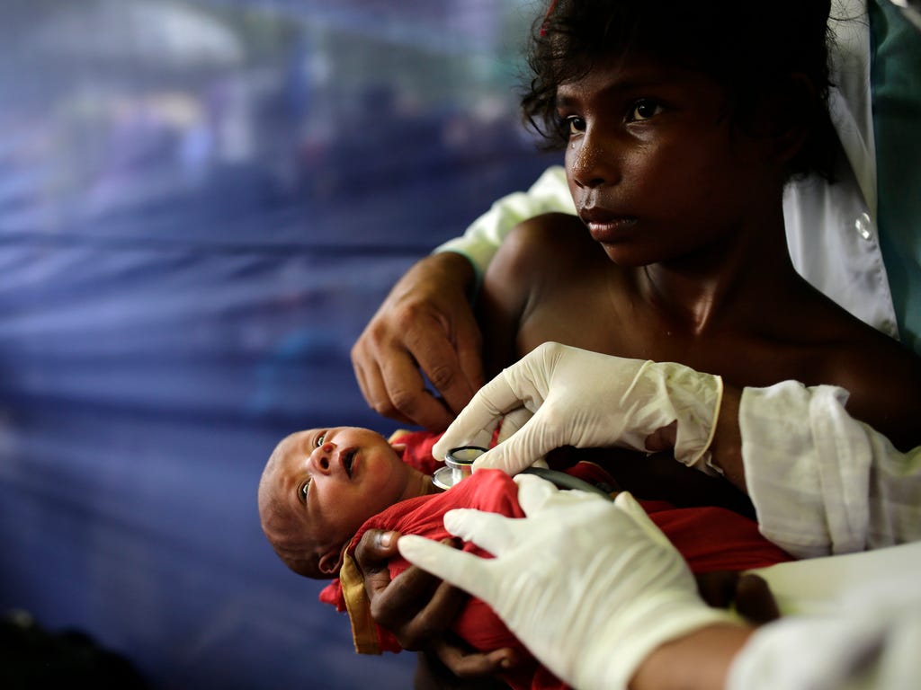 A doctor examines a 10-day-old Rohungya child in a medical center in a camp in Ukhiya, Bangladesh on Oct. 5, 2017. According to the United Nations High Commissioner for Refugees (UNHCR), more than 500,000 Rohingya refugees have fled Myanmar from viol