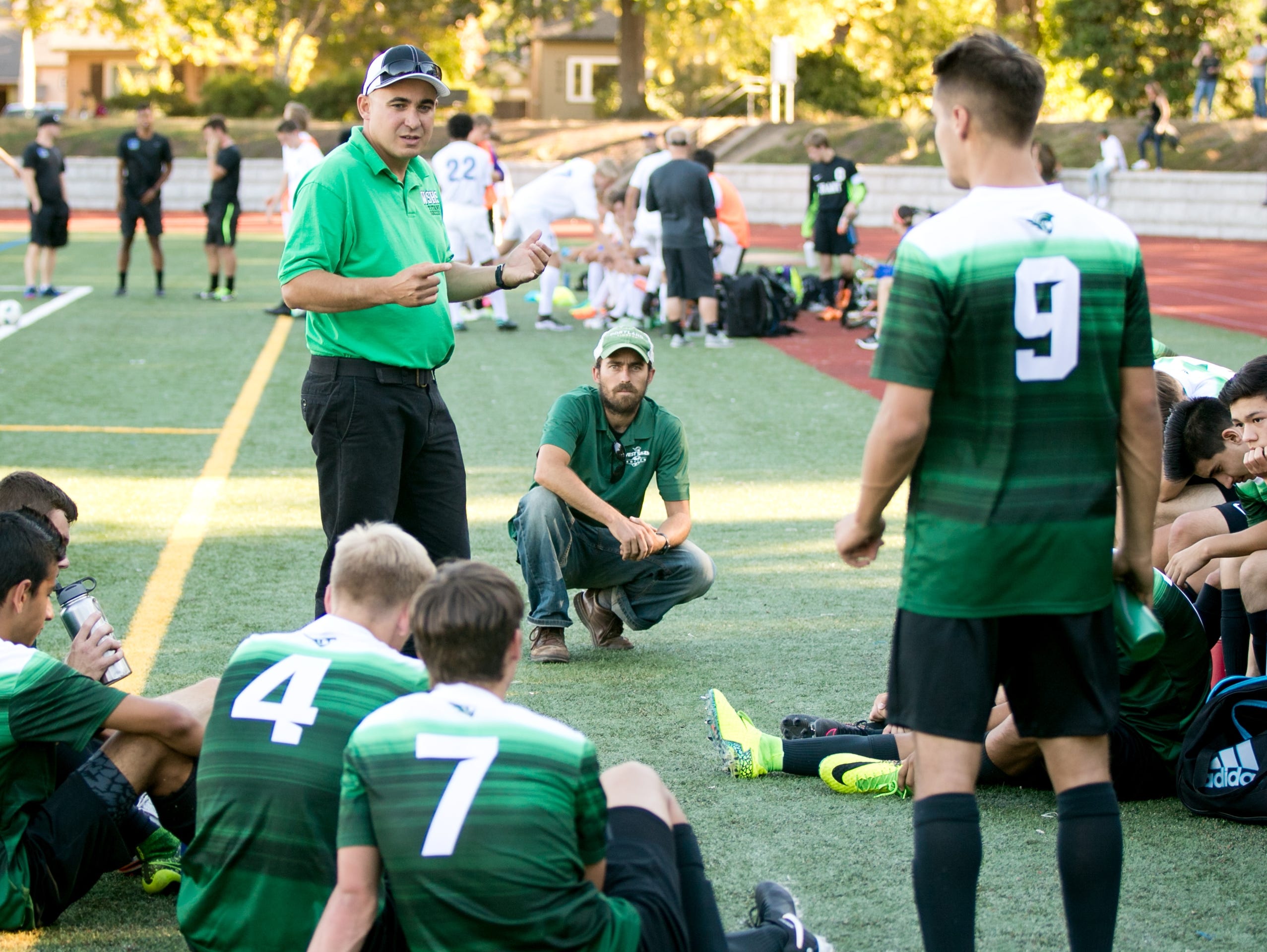 West Salem head coach Eddy Soboll talks to the team during halftime at a game against Grant High School on Tuesday, Sept. 13, 2016, in Portland, Ore. The West Salem Titans tied 1-1 with Grant.