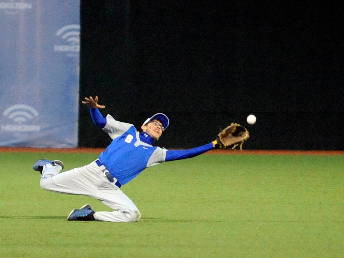 Alec Pinkerton dives to catch a fly ball April 14 during Southeastern's game against Huntington at VA Memorial Stadium.