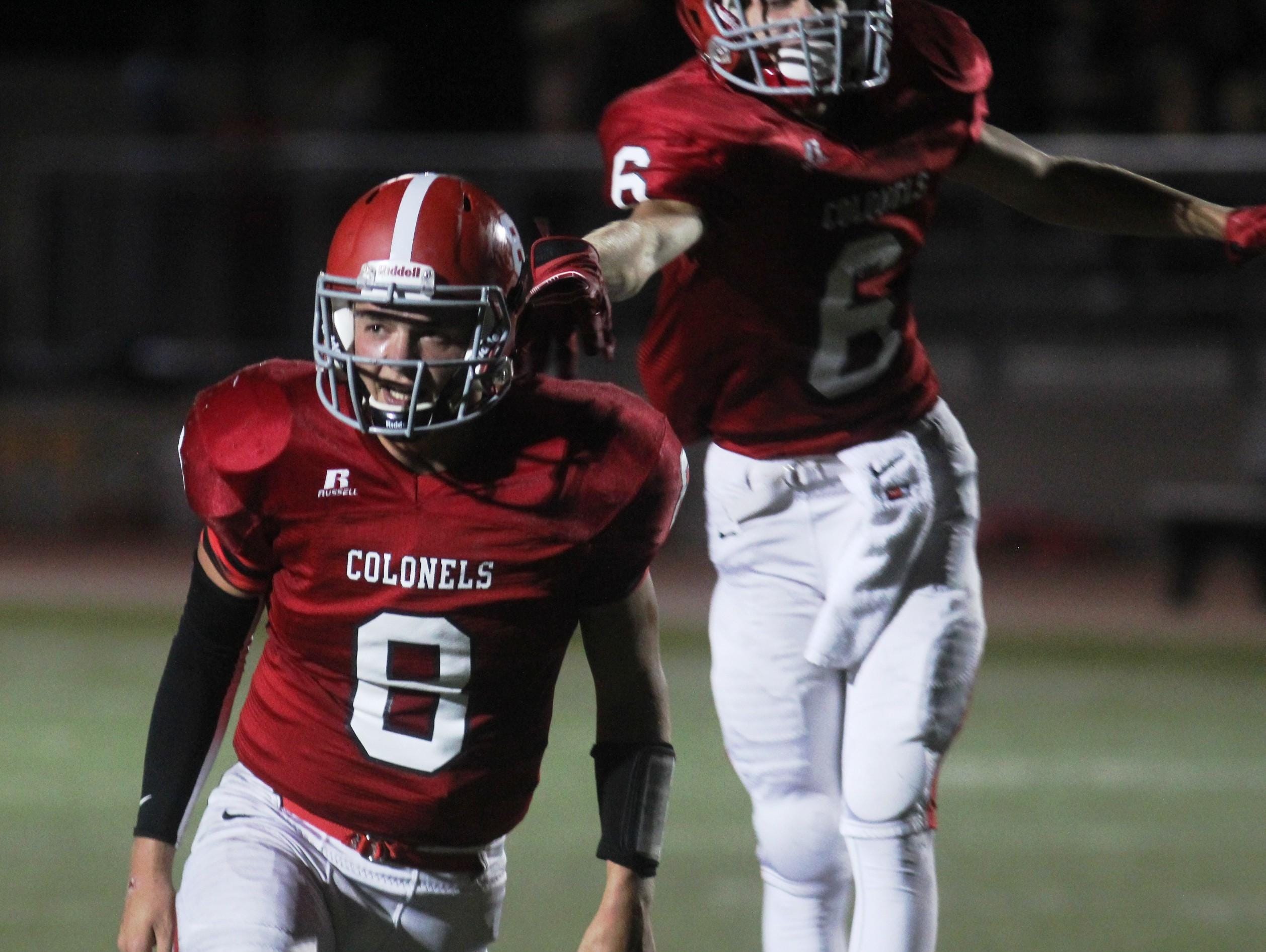 Dixie Heights’ Gunther Faeth, front, gestures to the crowd after his second touchdown run of the game against Boone County.