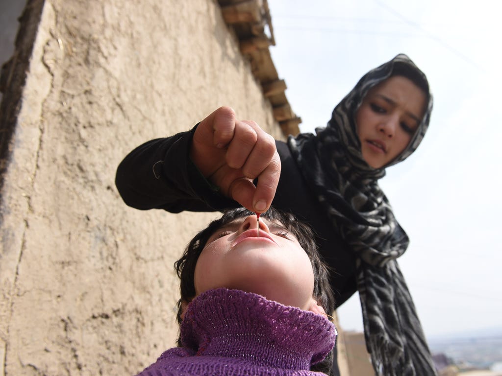A health worker administers a polio vaccine to a child on March 16 in Kabul, Afghanistan.