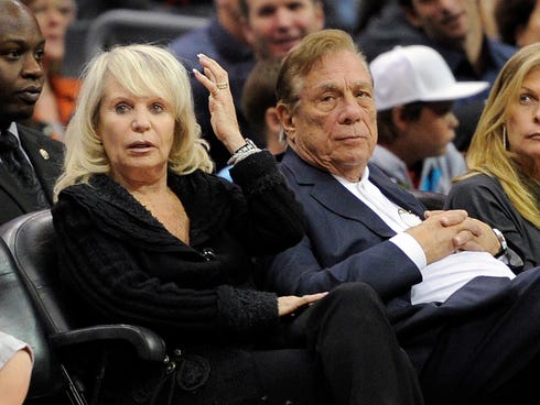 In this photo from 2010, Shelly Sterling sits with her husband, Donald Sterling, right, during a Los Angeles Clippers basketball game against the Detroit Pistons in Los Angeles. Shelly Sterling signed a binding agreement last week to sell the team, a