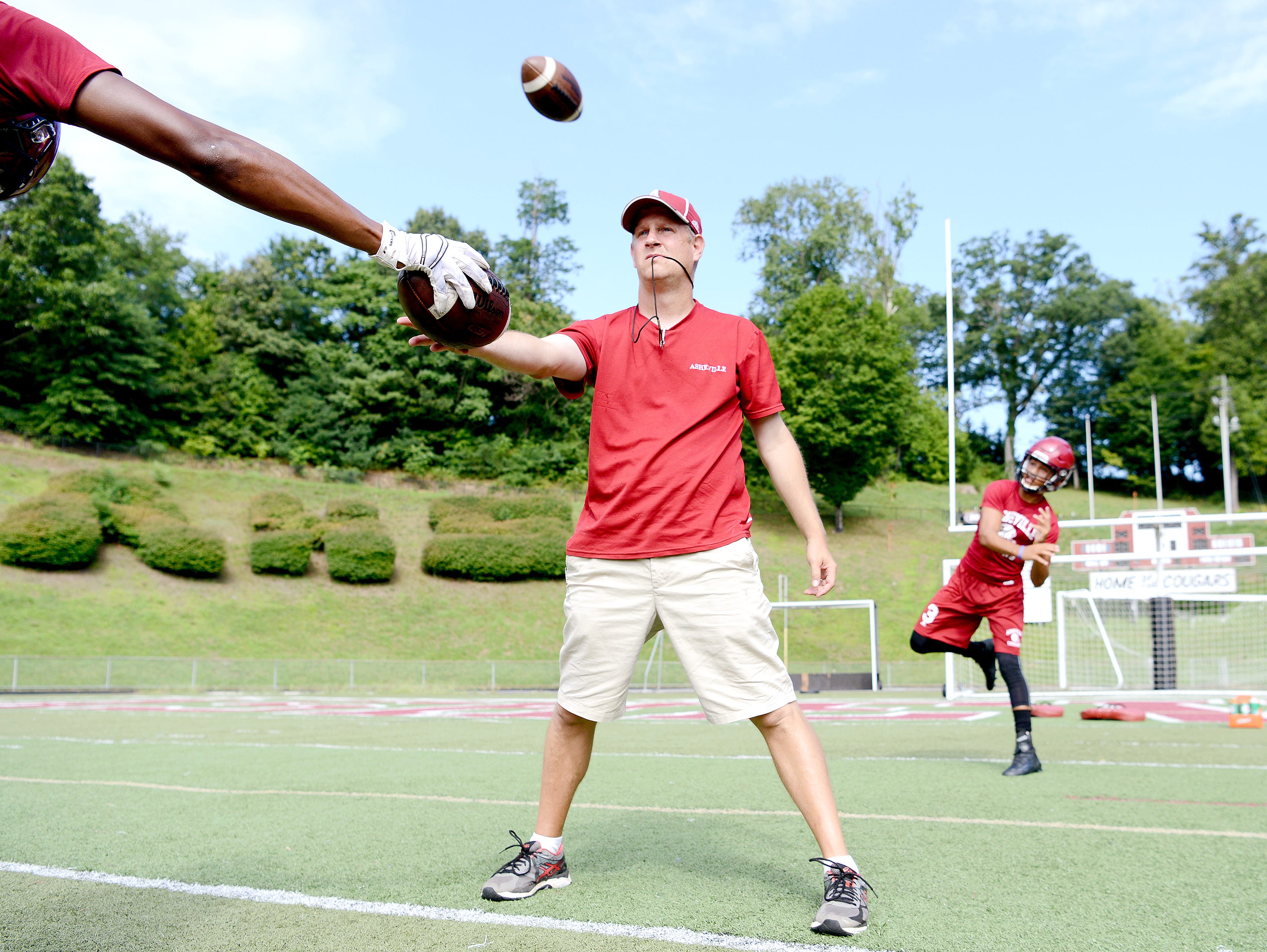 Devon Davidson throws a pass on the first day of official football practice for Asheville High on Aug. 1.