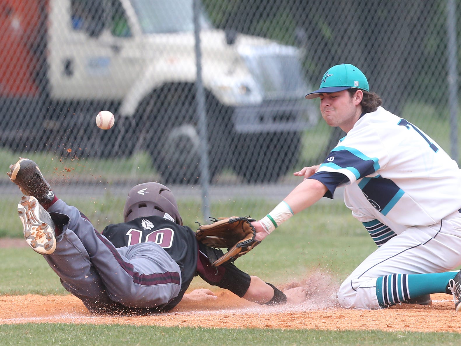 Siegel's Jordan Middleton (7) tries to tag out Collierville's Peyton Cathey (10) after Cathey took a lead off third base during Wednesday's Class AAA state tournament.