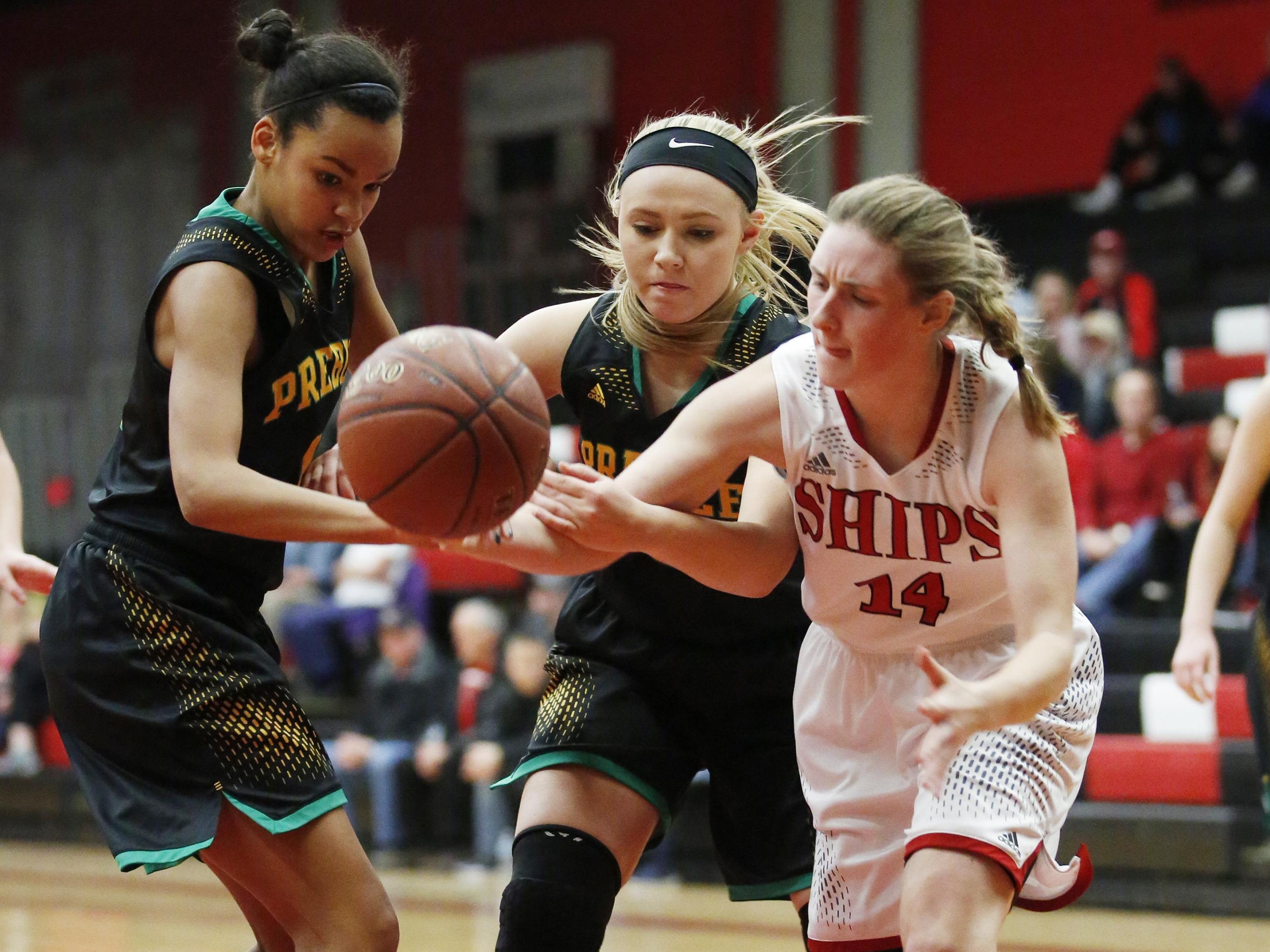 Green Bay Preble players battle with Manitowoc for a loose ball on Tuesday in Manty.