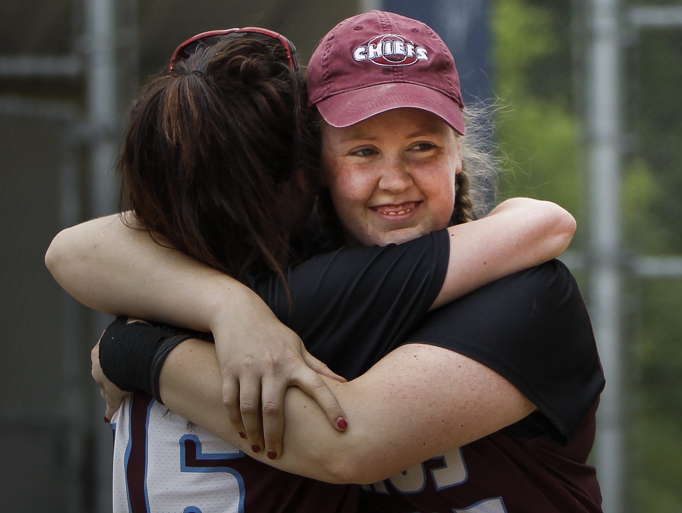 Okemos pitcher Sally Patterson, right, shares a moment with a teammate after leading her Chiefs to a 3-1 Div. 1 District Championship June 4, 2016, in East Lansing.