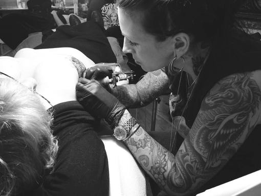 Tattoo artist Shannon Purvis Barron works on Martyn