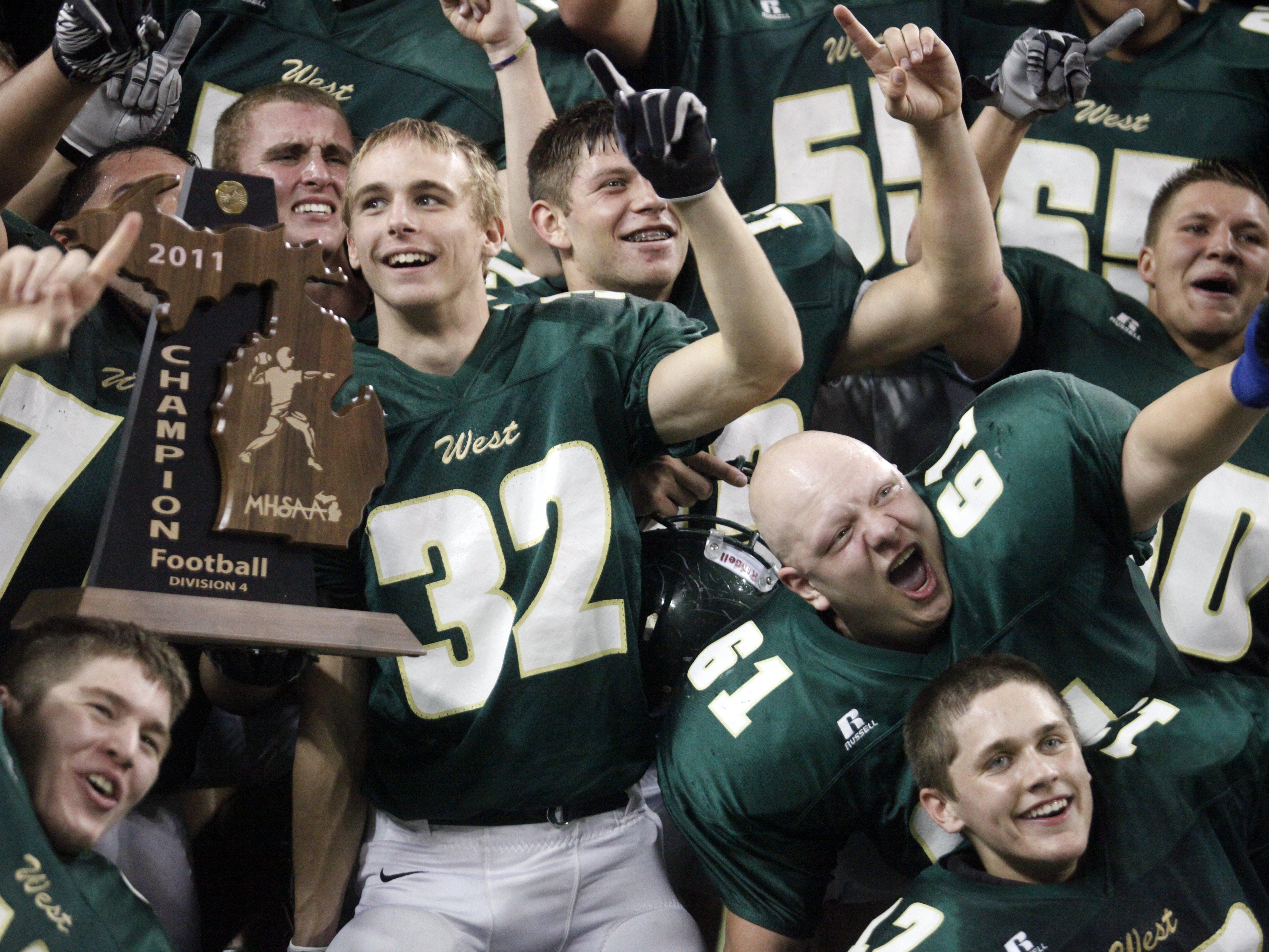 Zeeland West players celebrate their win on Friday, November 25, 2011 during the Michigan High School Football Division 4 Championship game at Ford Field. Zeeland West wins their last game of their perfect season against Marine City 45-7. JARRAD HENDERSON/Detroit Free Press