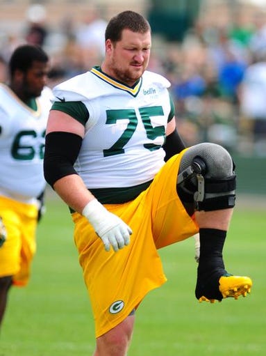 Green Bay Packers tackle Bryan Bulaga stretches during minicamp practice at Ray Nitschke Field, Thursday, June 19, 2014.