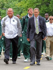 Michigan State athletic director Mark Hollis, left,