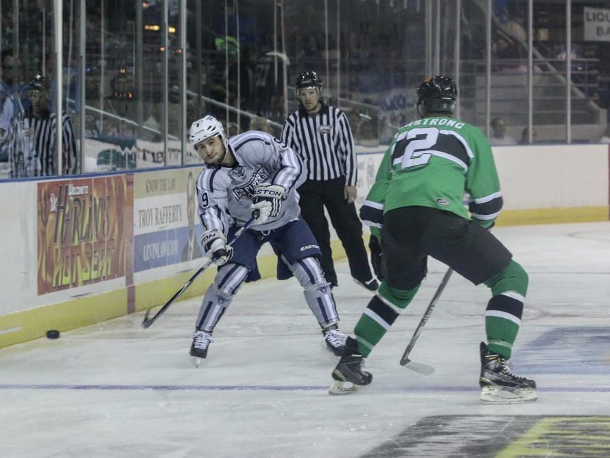 Stephen Buco, left, of the Ice Flyers gets the puck past Dan Cornell of the Lousiana IceGators during Friday night's game at the Pensacola Bay Center.