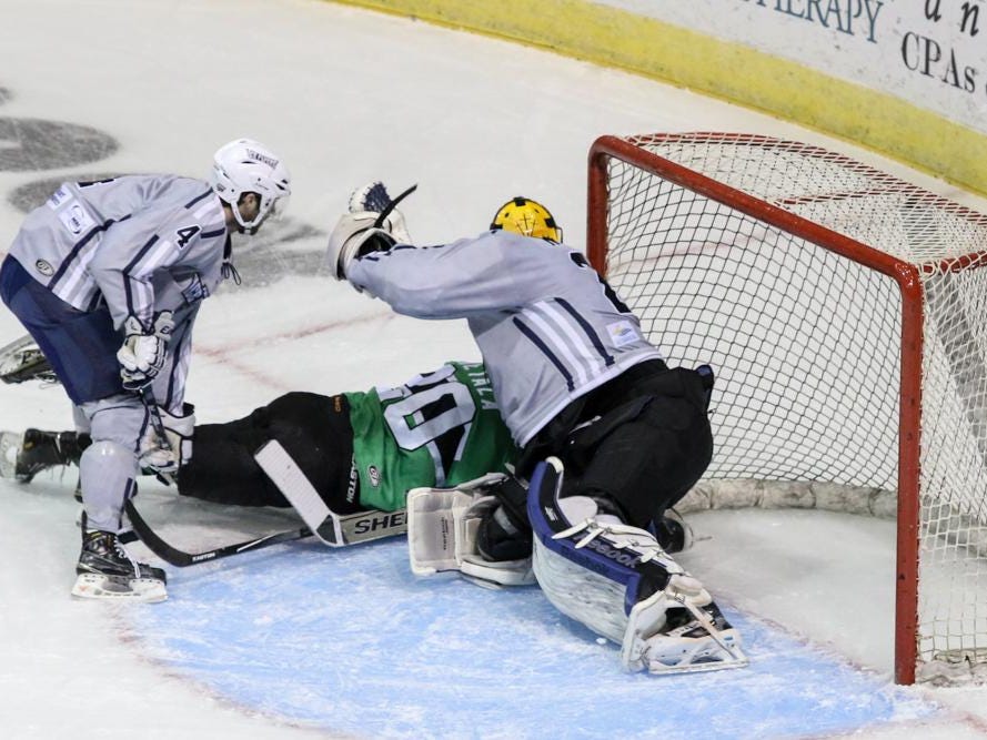 Mike Krieg, left, of the Pensacola Ice Flyers looks on as teammate Brent Troyan works to stop Blake Hietala of the Louisiana IceGators from getting a goal during Friday night's game at the Pensacola Bay Center.