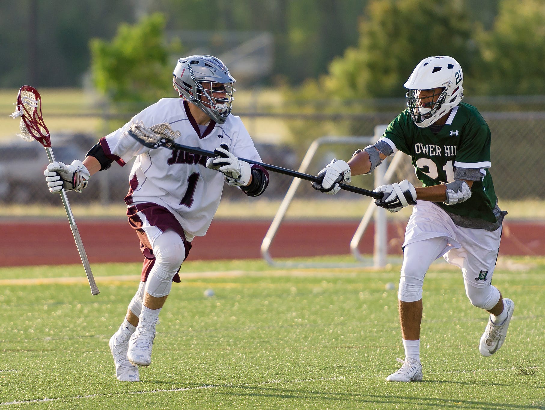 Zachary Bowen (1) of Appoquinimink works the ball past the defense of Tej Vaddi (31) of Tower Hill in the Tower Hill at Appoquinimink boys lacrosse game on Tuesday.