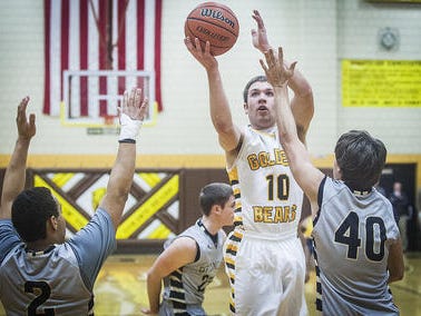 Monroe Central's Beau Combs shoots past the defense in a game last season.