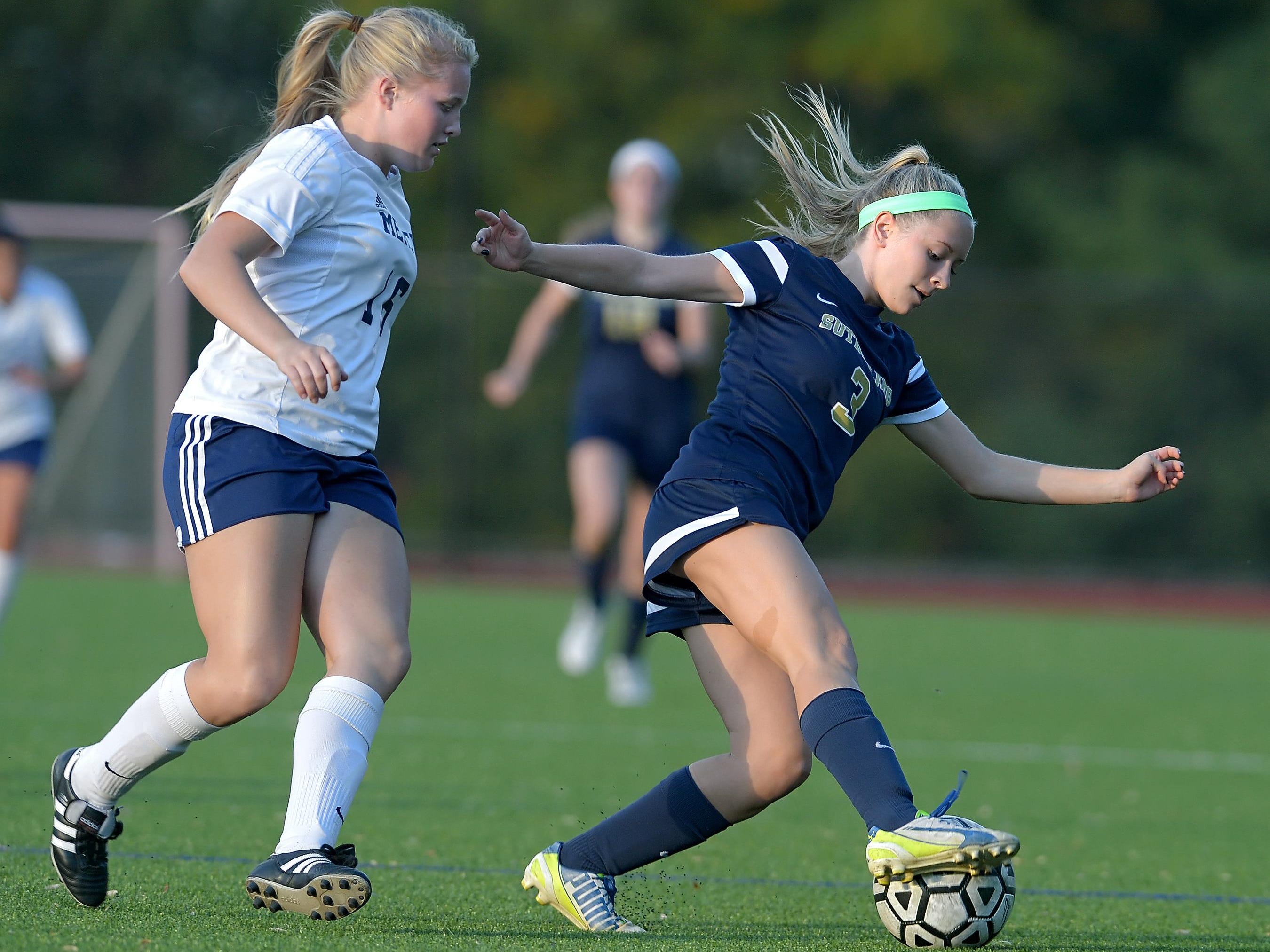 Pittsford Sutherland's Julia Stone, right, turns the ball away from Mercy's Ingrid Donnan.