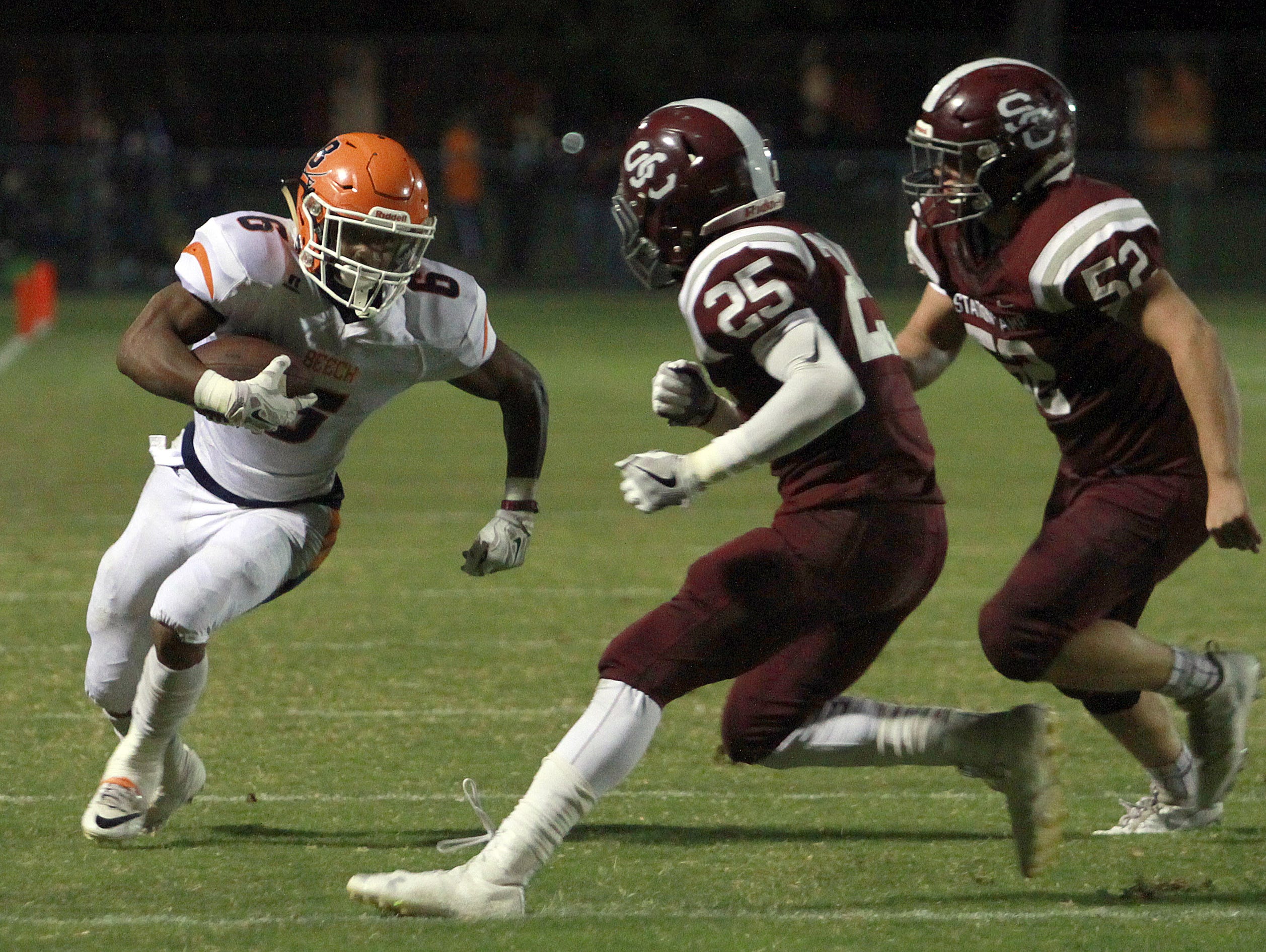 Beech's Alex Vanzant rushes as Station Camp's Shawn McKinley (25) and Simon Freeman force him to the sideline and short of the goal line during their game earlier this season. Beech is ranked ninth in this week's Class 5A poll and hosts Hunters Lane on Friday.