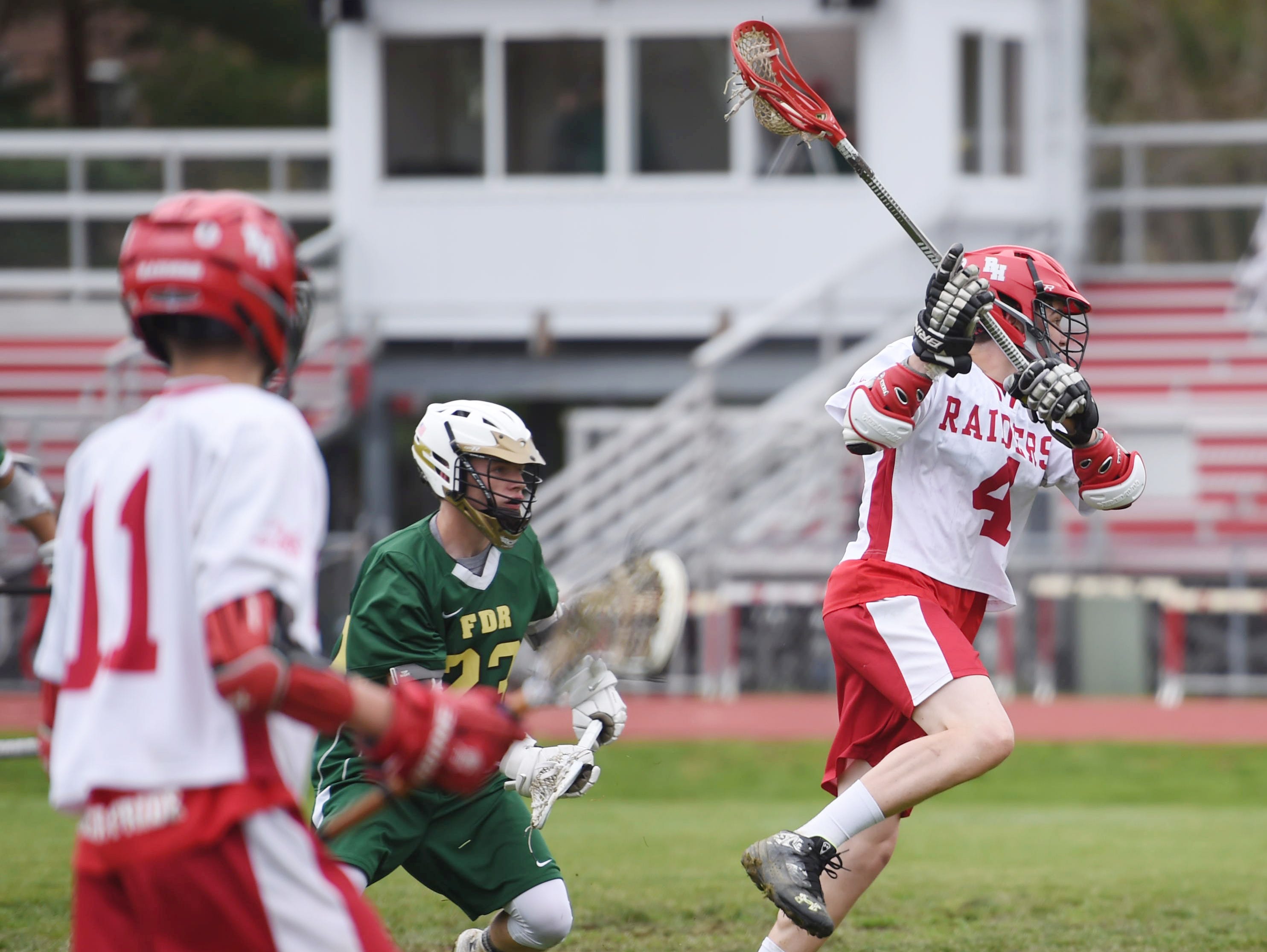 Red Hook's Cam Hackett leaps ahead of FDR's Travis Slocum to take a shot on goal during Tuesday's home game.