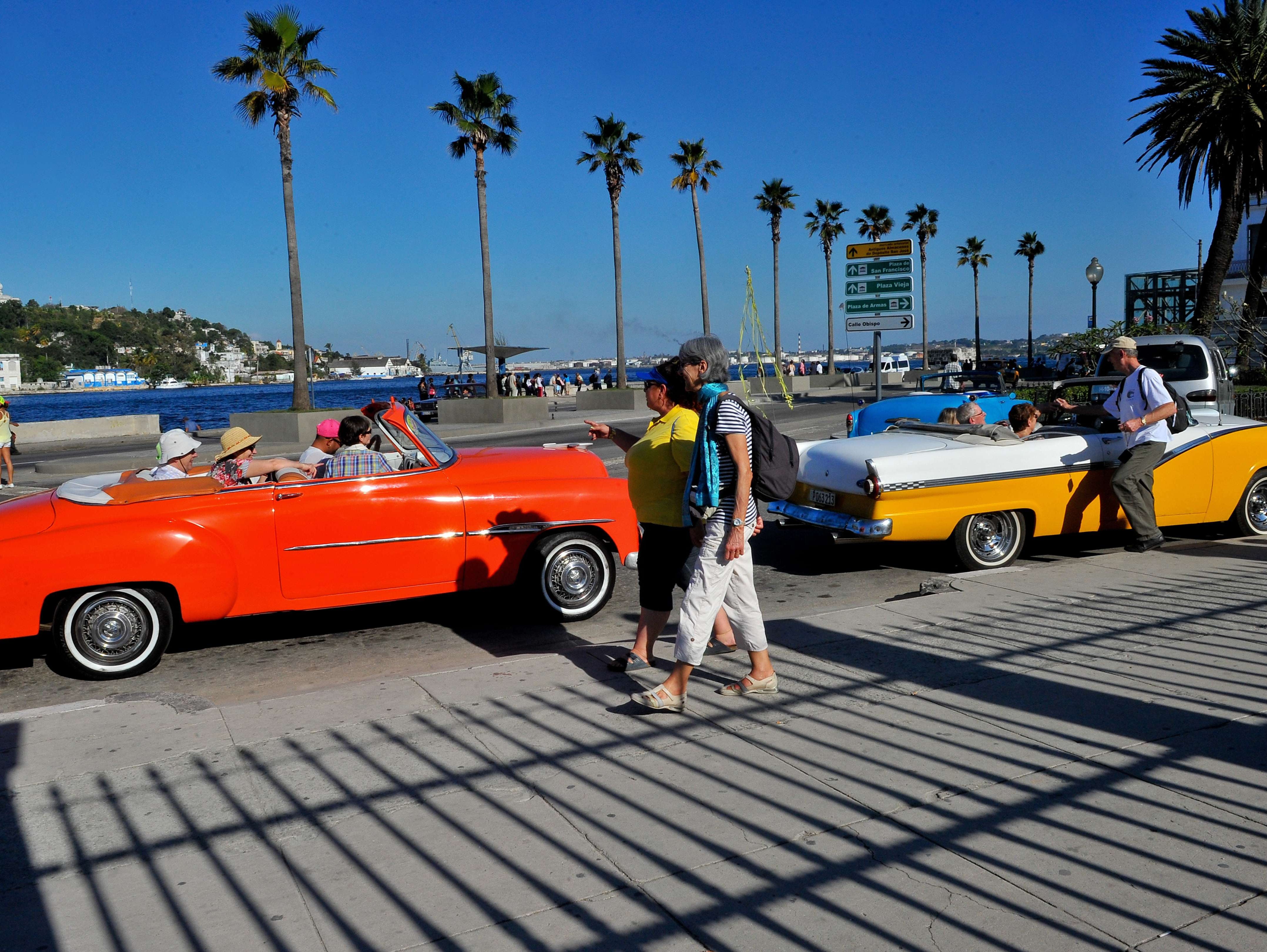Tourists from the United States are seen in old American cars in Havana, on April 6, 2015.