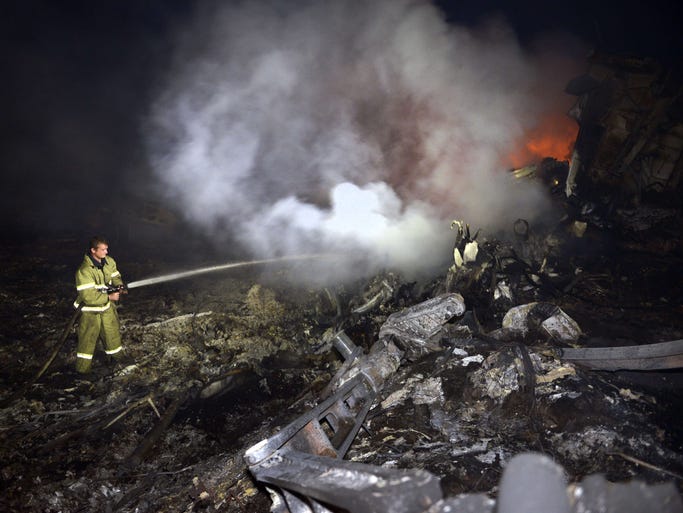 A firefighter puts out fires in the wreckage of Malaysian Airlines flight MH17 that crashed near the town of Shaktarsk, in rebel-held east Ukraine.