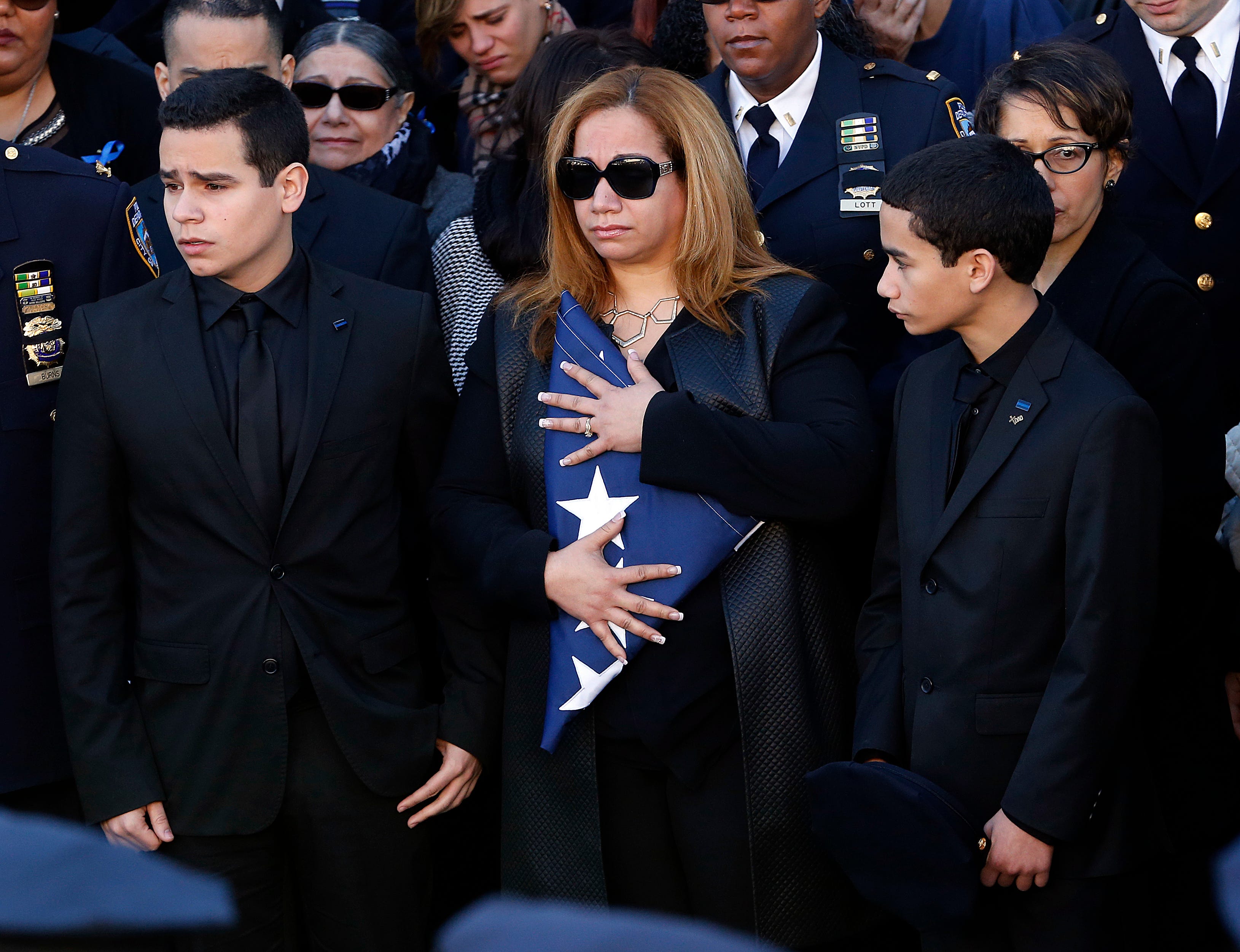 De Blasio speaks at funeral; officers turn their backs