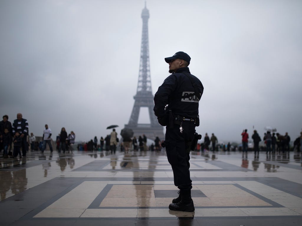 A French police officer patrols at Trocadero plaza with the Eiffel Tower in the background in Paris, France on May 6, 2017. Voting for France's next president starts in overseas territories and French embassies abroad, as a blackout on campaigning de